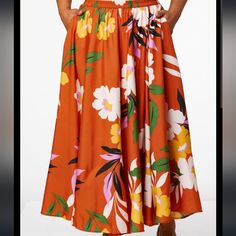 You'll Turn Heads In This Silky Skirt With Burnt Orange Background And Bold Floral Print. * Long Skirt * Elastic Waist * 100% Polyester * Machine Wash * Imported Floral Print Full Skirt Bottoms For Day Out, High Waist Floral Print Maxi Skirt In Relaxed Fit, High Waist Relaxed Floral Maxi Skirt, Vacation Floral Print Full Skirt Bottoms, Floral Print Full Skirt Bottoms For Vacation, Floral Print Full Skirt For Vacation, Floral Print Skirted Bottoms For Beach, Beach Skirted Bottoms With Floral Print, Spring Vacation Full Skirt