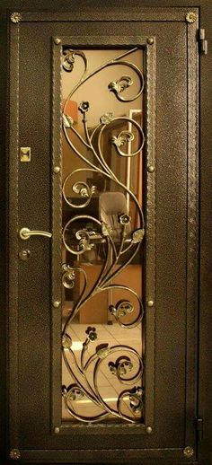 an ornate metal door with glass panels