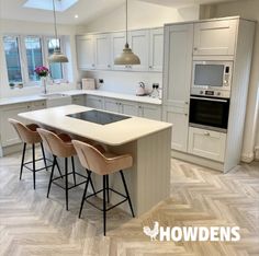 an image of a kitchen setting with stools and island in the middle for seating