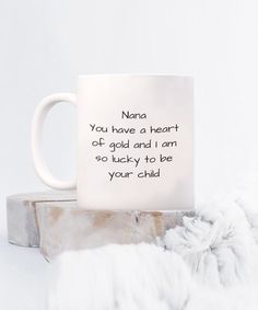 a white coffee mug with the words nana you have a heart at gold and i am so lucky to be your child