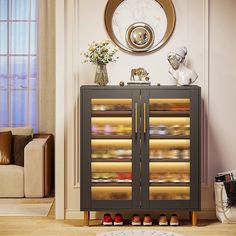 a glass door cabinet with shoes on it in a living room next to a couch