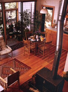 an overhead view of a living room and dining area with wood floors, furniture, and a fireplace