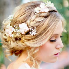 a woman with blonde hair and flowers in her hair