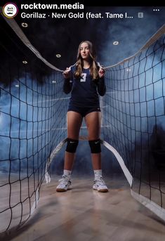 a female volleyball player posing in front of a net