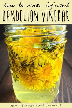 a mason jar filled with dandelion flowers on top of a wooden table and text overlay reads how to make infused dandelion vinegar