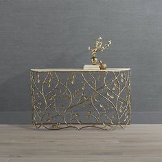 an ornate gold console table with flowers on top