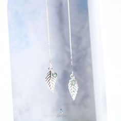 Discover the beauty and elegance of these sterling silver leaf ear threader earrings. The delicate leaf design hangs from a threader ear wire, connected by a box chain for a unique and stylish look. With a highly polished finish, these earrings sparkle and shine, and are lightweight for comfortable everyday wear. A perfect addition to any fine jewelry collection or as a thoughtful gift for a loved one. Sold as a pairMaterials: 925 sterling silver, KyaniteLength: 3 in Jewelry Care: See more infor Silver Sterling Linear Earrings With Adjustable Chain, Delicate Sterling Silver Chain Earrings, Sterling Silver Earrings With Delicate Chain, Silver Sterling Earrings With Delicate Chain, Dainty White Gold Sterling Silver Threader Earrings, Silver Threader Earrings With Adjustable Chain As Gift, Silver Threader Earrings With Adjustable Chain, Silver Adjustable Threader Earrings, Silver Dangle Threader Earrings With Delicate Chain