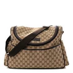 This is an authentic GUCCI Monogram Natural Pigskin Diaper Bag in Beige, Ebony, Cocoa, and Dark Chocolate. This chic diaper bag is crafted of brown on beige Gucci GG monogram canvas. The bag features elastic sidepockets, brown leather trim, and an adjustable nylon shoulder strap with dark silver hardware. The top zipper opens to a cocoa brown nylon interior with zipper and patch pockets and a removable changing pad. Gucci Diaper Bag, Designer Diaper Bag, Gucci Crossbody Bag, Gucci Crossbody, Gg Monogram, Gucci Monogram, Cocoa Brown, Gucci Shoulder Bag, Pig Skin