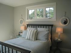 a bedroom with a bed and two lamps