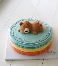 there is a cake with a teddy bear on it