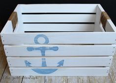 a wooden crate with an anchor painted on it