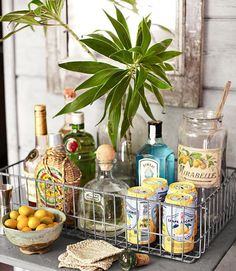 a table topped with bottles and baskets filled with drinks