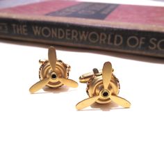 These cufflinks are made with moveable raw brass air plane propellers.  The base measures 1/2" in diameter by 1/8" tall and the blades are 3/4" in diameter (5mm x 10mm x 21mm). They are soldered to gold plated cuff links. Please note that these are raw brass and will develop a patina over time.  If you wish them to go back to their shiny gold appearance, simply buff with a polishing cloth. If you'd like more for a wedding party or another special occasion please contact me! Wright Brothers, Air Plane, Kitty Hawk, Tie Accessories, Suit And Tie, Cuff Links, Raw Brass, Cufflinks, Wedding Party