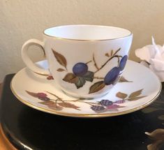 a cup and saucer sitting on top of a table