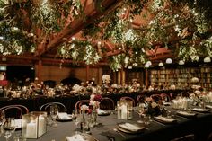 the tables are set for an event with candles and centerpieces