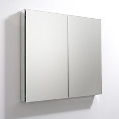 a mirror mounted to the side of a white wall