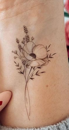 a woman's foot with a flower tattoo on it