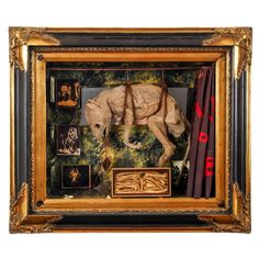 an animal is in a gold frame with other items around it and on the wall