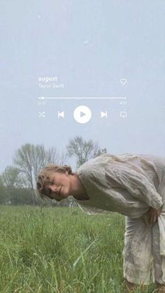 a woman standing in the middle of a field