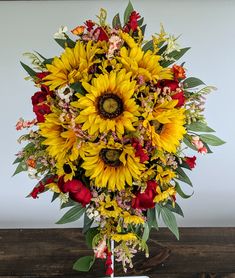 a bouquet of sunflowers and other flowers on a table