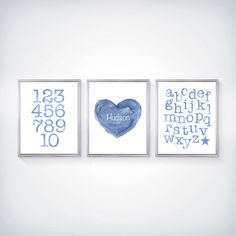 three blue prints with numbers and a heart in the middle are hanging on a wall