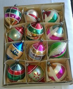 an open box filled with assorted christmas ornaments