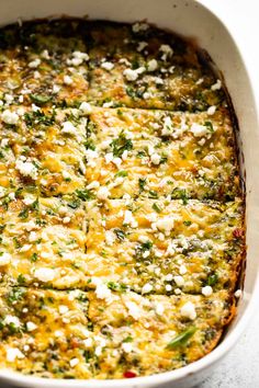 a casserole dish filled with cheese and vegetables