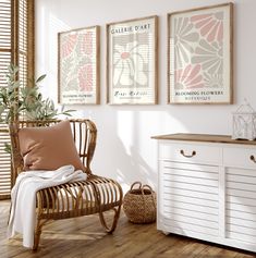 a white chair sitting next to a wooden dresser under three framed pictures on the wall