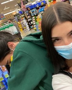 a woman wearing a face mask in a grocery store