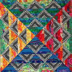 a colorful quilt with many different designs on it