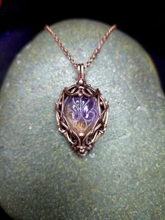 This beautiful gemstone has a mix of citrine and amethyst for a perfect mix of colours and has been carved with a gorgeous floral design. This Citrine has been hand wrapped in a stunning copper design that showcases the beauty of the stone. Ametrine holds many of the energetic properties of Amethyst and Citrine, such as the tranquility and peace of Amethyst and the creativity and joy of Citrine. The duality of Ametrine represents balance - the balance of feminine and masculine energies, your per Citrine Gemstone Oval Pendant Jewelry, Amethyst Gemstone Oval Pendant, Elegant Purple Pendant Gemstones, Amethyst Multi-stone Pendant Jewelry, Amethyst And Citrine, Purple Multi-stone Pendant Gemstones, Copper Design, Gemstone Pendant Necklace, Hand Wrap