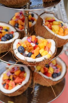 several trays filled with fruit on top of a metal platter next to each other