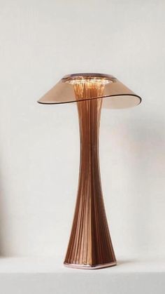 a table lamp sitting on top of a white shelf