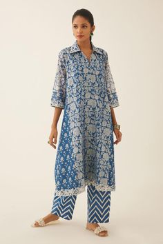 Blue A-line short kurta with bouquet hand block print and sequin, tassel, bead embroidery on collar and sleeve hem. Paired with chevron hand block printed straight pant.
Components: 2
Pattern: Hand Block Printed, Embroidery
Type Of Work: Bouquet, chevron, sequin, tassel, bead
Neckline: Shirt collar
Sleeve Type: Three quarter
Fabric: Kurta: Silk Chanderi, Pant: Cotton
Color: Blue
Other Details: 
Lined kurta
Embroidered neckline and sleeve hem
Elasticated waist at the back
Side pockets
Occasion: M A Line Kurti Designs Latest Cotton, Block Print Kurti Designs, A Line Kurti Designs, Short Kurti Designs, Printed Kurti Designs, Collar Kurta, Simple Kurti, A Line Kurti, Printed Embroidery