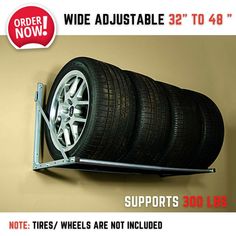 there is a tire mounted on the wall with two wheels attached to it and an advertise that reads, wide adjustable 32't0 48 '