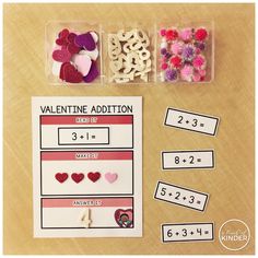 valentine's day addition cards with hearts and numbers in plastic containers on a table