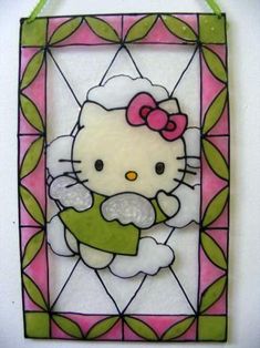 a hello kitty stained glass window hanging on a wall