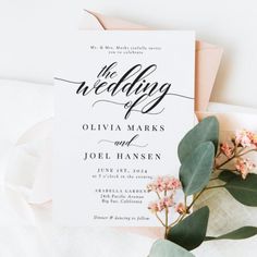 the wedding stationery is laid out on top of some flowers