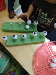 two children are playing with golf balls on the table