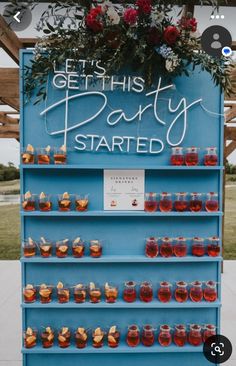 a blue sign that says get this party started with honey jars and flowers on it