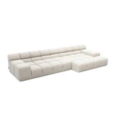 a white sectional couch sitting on top of a white floor