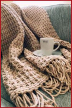 Cozy knit blanket draped over a couch with a coffee mug on a saucer. Easy Chunky Crochet Blanket, Easy Crochet Blanket For Beginners, Crochet Blanket For Beginners, Hobby Corner, Tunisian Crochet Blanket, Chunky Crochet Blanket Pattern, Cross Stitch Knitting, Chunky Crochet Blanket, Crochet Cross Stitch