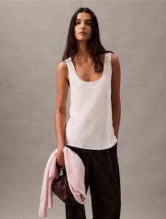 Airy and lightweight, this relaxed tank top has a bias cut for a soft, gentle drape. Styled with a sleeveless silhouette and a scoopneck. Wear with a pair of loose fit trousers for an effortless look.  Material: 100% Viscose. Fitted Trousers, Scoop Neck, Calvin Klein, Loose Fitting, Trousers, Tank Tops, How To Wear