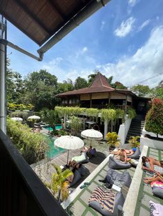 people are lounging on bean bags near the pool