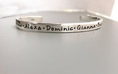 A sterling silver shiny cuff bracelet with your message, names, and/or dates stamped on bracelet. This bracelet is of incredible quality. SIZE…………………………………………………………….Length: 15cm or 6” Height :  5.0mm or .02"Width: 2mm  Gauge: 13FONT…………………………………………………………….Font shown: Whimsy (photo 1/3)  TYPE CAP (photo 2)   **but can be most fonts in last picture      Will happily leave letters unblackened or buff a matte finish if you prefer.  Leave In Notes to Seller at checkout. CHECKOUT..................... Silver Hand Stamped Cuff Bracelet As A Gift, Silver Cuff Bracelet Hand Stamped Gift, Personalized Sterling Silver Cuff Bracelet, Customizable Silver Bracelets With Meaningful Style, Silver Hand Stamped Bangle Bracelets, Sterling Silver Hand-stamped Bracelet, Silver Hand Stamped Bangle, Hand Stamped Silver Bangle Bracelets, Adjustable Silver Hand Stamped Cuff Bracelet