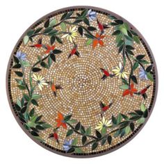 a mosaic plate with flowers and leaves on it