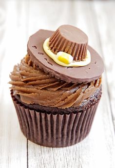 a cupcake with chocolate frosting and a hat on top