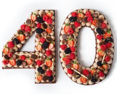 the number forty four made out of fruit and nuts is displayed in front of a white background