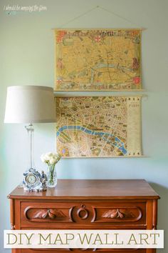 a wooden table with a lamp on it and a map hanging above the top that says diy map wall art