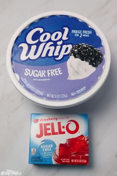 a bowl of jello next to a card on a counter top with the word cool whip written in it